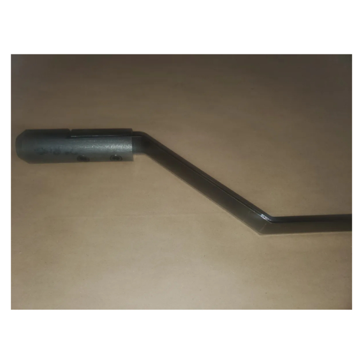 close up photo of offset blade with adapter attached to it on a brown background