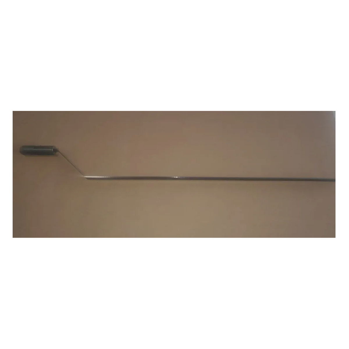 long offset foam cutting blade with adapter attached on a brown background