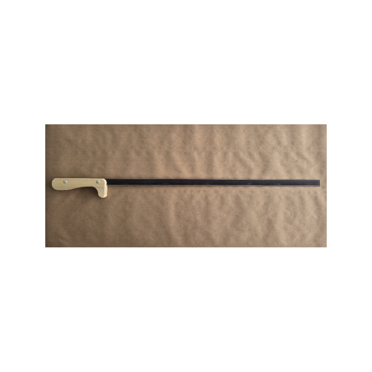 long saw with wooden handle on a brown background